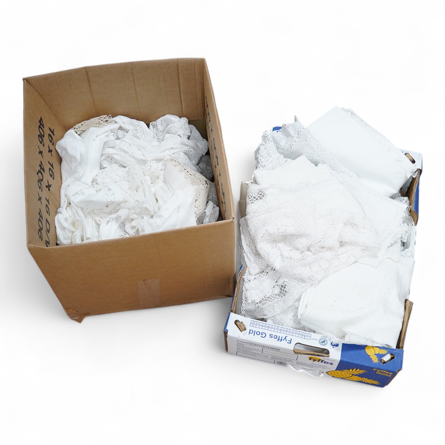 Two boxes of mixed white on white embroidered linen and cotton table cloths etc, some with crochet edging and cut work.